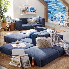 a living room filled with blue couches and furniture