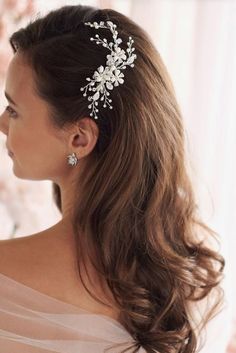 a woman wearing a hair comb with flowers on it