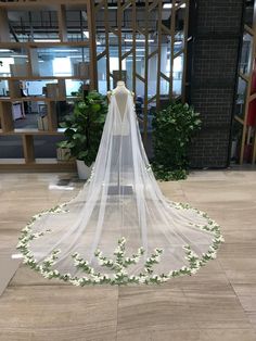 a wedding veil with flowers on the floor