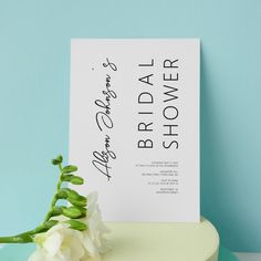 a white flower sitting on top of a table next to a sign that says bridal