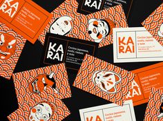 an assortment of business cards with orange and white designs on them, including the logo for ka ra