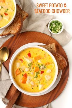 there is a bowl of soup on the table with bread and green onions next to it