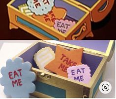 an open wooden box with some decorations in it and the words eat me next to it