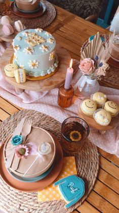 a table topped with cakes and cupcakes on top of wooden tables covered in doily