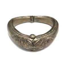 *Description: This is a great embossed design tribal bracelet with a hinge and plunger clasp which makes it very easy to take on and off from the 1940s. The plunger stays attached so you don't have to worry about loosing it. The bracelet has a gold wash, which I tested at 10K gold surface metal. The bracelet under the gold wash is a non-magnetic brass metal; probably mostly hollow. The shape of the bracelet is very unique and is more of a triangular shape with the flat portion on the bottom behi Vintage Ceremonial Cuff Bracelet With Intricate Design, Antique Hinged Cuff Bracelet Bangle, Antique Hinged Cuff Bracelet, Antique Hinged Bangle Cuff Bracelet, Vintage Engraved Cuff Bracelet For Ceremonial Occasions, Vintage Ceremonial Stamped Cuff Bracelet, Antique Carved Bangle Jewelry, Vintage Hinged Bangle Bracelet, Vintage Ceremonial Bangle With Antique Finish