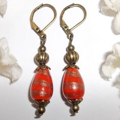 Bronze And Orange Glass Beaded Earrings Nwt Boho Style Earring Set Pair 5463 This Beautiful Boho Earring Set Is Brand New & Handmade By Me - Wvluckygirl. Done With Teardrop Shaped Orange Glass Beads With A Goldish Bronze Metallic Design. They Also Have Antiqued Bronze Toned Costume Jewelry Beads. The Pair Dangle & Drop From Lever Backs For Women's Pierced Ears. Measure 1 7/8 Inches Tall & 3/8 Inch Wide. Each Single Earring Weighs 2.4 Grams. Lightweight! Bohemian Style Fashion Accessory Leverback Vintage Orange Earrings With Czech Glass, Vintage Orange Czech Glass Earrings, Elegant Orange Earrings With Dangling Beads, Elegant Orange Beaded Earrings As A Gift, Handmade Elegant Orange Beaded Earrings, Elegant Orange Beaded Dangling Earrings, Elegant Handmade Orange Beaded Earrings, Nickel-free Orange Beaded Drop Earrings, Orange Teardrop Beaded Earrings For Gift