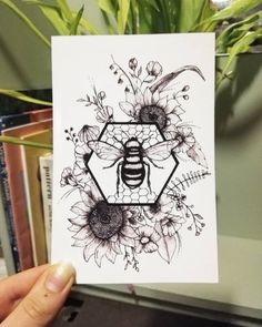 a person holding up a card with a bee on it