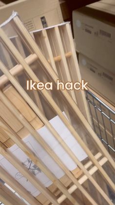 a pile of wooden sticks sitting on top of a metal rack next to cardboard boxes