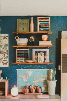 there is a desk with many items on the shelves and in front of it are bookshelves