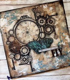 an altered clock is displayed on a wooden surface with peeling paint and other things around it