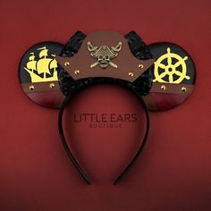 a mickey mouse ears headband with pirate symbols on it