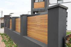 a modern house with wood slats on the side