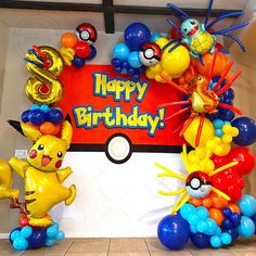 some balloons are in the shape of pikachu and other pokemon characters on display