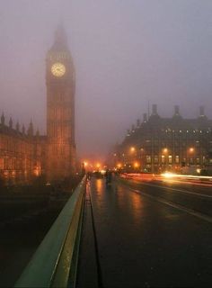 the big ben clock tower towering over the city of london on a foggy night