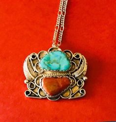 This 1970's classic floral overlay Native American made sterling silver natural blue turquoise stone and natural coral and sterling silver square pendant/brooch is a wonderful classic. The pendant is 1 1/2 inches tall and 1 5/8 inches wide. It is signed sterling and hallmarked GY on the back. I paired it with a sturdy 23 inch silver tone (NOT sterling) chain just so you can have a ready chain. This fabulous vintage brooch. I specialize in finding fun wearable jewelry. Please browse my shop for m Southwestern Multi-stone Jewelry For Anniversary, Southwestern Multi-stone Pendant Jewelry, Southwestern Style Collectible Jewelry With Large Stone, Southwestern Style Large Stone Collectible Jewelry, Rectangular Turquoise Jewelry For Collectors, Bohemian Sterling Silver Jewelry With Square Pendant, Collectible Rectangular Turquoise Jewelry, Vintage Turquoise Pendant Necklace With Natural Stones, Vintage Turquoise Jewelry With Large Pendant