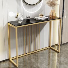 a white and gold console table with a clock on the wall behind it, along with other accessories