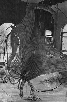 an old photo of the inside of a boat with ropes on it's side