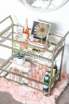 a gold bar cart with drinks on it