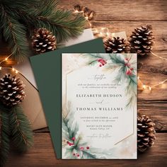 a wedding card with pine cones and evergreen leaves on it, surrounded by christmas lights