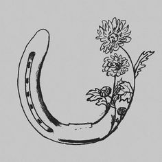 a black and white drawing of a horseshoe with flowers in it