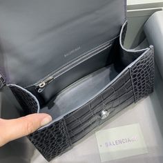 SHOP MORE LUXURY PRODUCTS HERE Description Balenciaga Hourglass Small Handbag In Dark Grey, For Women, Women’s Bags 9in/23cm 5935461LR6Y1309 Size:ÃƒÂ¯Ã‚Â¿Ã‚Â½ÃƒÂ¯Ã‚Â¿Ã‚Â½ÃƒÂ¯Ã‚Â¿Ã‚Â½ÃƒÂ¯Ã‚Â¿Ã‚Â½ 23 x 15 x 10 cm / 9 x 5.9 x 3.9 inches (Lenght x Height x Width) HandbagCurvilinear baseOne handleAdjustable and removable crossbody strapStudded magnet closureB logo hardware1 back pocket1 inner zipped pocket Includes box, dust bag.This product is of the premium quality. Luxury Rectangular Bags With Detachable Handle, Luxury Rectangular Bag With Detachable Handle, Designer Flap Bag With Top Handle And Removable Pouch, Designer Flap Shoulder Bag With Top Handle, Designer Shoulder Flap Bag With Top Carry Handle, Designer Top Handle Flap Bag With Removable Pouch, High-end Rectangular Bag With Detachable Handle, Luxury Rectangular Bag With Top Carry Handle, Luxury Pouch Box Bag With Top Carry Handle