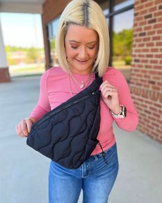 a woman is holding onto her black purse