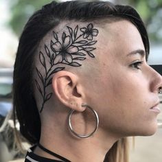 a woman with a flower tattoo on her head