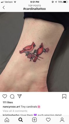 a small bird tattoo on the ankle is shown in this instagramtion photo, which shows two red birds perched on a branch with pink flowers