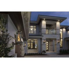 a modern house at night with the lights on