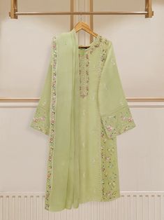 Elegant embroidered cotton net shirt with pants and dupatta a perfect choice for those who appreciate intricate detailing and graceful style. Crafted from high-quality cotton net fabric, this shirt offers a lightweight and luxurious feel, allowing you to feel comfortable and chic throughout the day. The set comes with a matching dupatta and pant which enhances the overall look and adds a touch of finesse to your outfit. Length: 45" Pants Fabric : Raw Silk Dupatta Fabric : Organza Kamiz Design, Agha Noor, Simple Kurti, Kurti Dress, Embroidery Dresses, Pista Green, Organza Shirt, Embroidered Suit, Square Cake