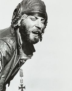 a black and white photo of a man wearing a leather jacket