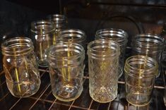 there are many glass jars on the rack in the oven, and one is empty