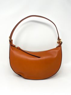 Expertly crafted in Italy from supple calfskin leather, this bag features a slouchy, moon shape that can be worn over the shoulder or as an elegant crossbody. It is finished with a new signature twisted buckle in lustrous antique brass. Details: Leather. Dimensions: Height: 21CM. Width: 34CM. Depth: 8CM. Handle Drop: 20CM (Shortest Strap) 58CM (Longest Strap) Evening Brown Hobo Bag With Palladium Hardware, Elegant Saddle Shoulder Bag With Gold-tone Hardware, Chic Calf Leather Hobo Bag With Smooth Grain, Evening Saddle Shoulder Bag With Gold-tone Hardware, Timeless Smooth Grain Hobo Bag, Timeless Hobo Bag With Smooth Grain, Designer Saddle Shoulder Bag For Evening, Chic Smooth Grain Saddle Bag For Work, Chic Cognac Shoulder Bag With Palladium Hardware