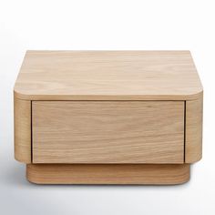 a wooden box sitting on top of a white surface