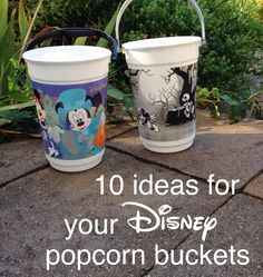 two buckets sitting on top of a sidewalk with the words 10 ideas for your disney popcorn buckets