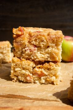 three pieces of cake sitting next to an apple