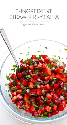 a bowl filled with sliced strawberries and cilantro