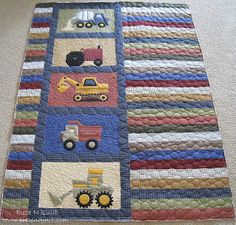 a quilted wall hanging with trucks and tractors on it's sides in the shape of squares