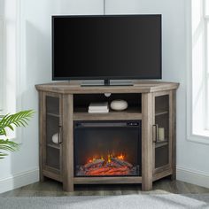 an entertainment center with a fireplace and flat screen tv mounted on it's sides