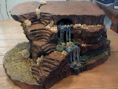 a fake waterfall in the middle of a wooden table