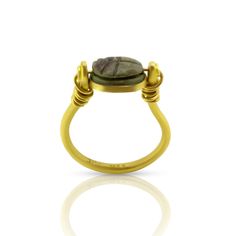 Gold & Stone Ring, Size 7-8 - Rare and exciting, this ring boasts an authentic 3000 year old faience and paste scarab, set in pure 22 karat gold in an ancient inspired mounting. Showing the hieroglyphs underneath, this scarab dates back circa 1300 BC from the New Kingdom of Egypt. The ring is designed as an ancient style swivel to show either the front or back.<br><br>Scarabs were worn as jewelry and amulets in Egypt. Being a common form like a charm, both rich and poor alike wor Kingdom Of Egypt, Gold Stone Ring, Rich And Poor, 22k Gold Ring, Good Luck Symbols, Painting Lamp Shades, Egyptian Scarab, Gold Stone, Amulets