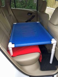 the back seat of a car with a blue mat on it