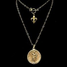 The light and airy Wisdom Chain Peace Angel Necklace is designed so it is long enough to be worn double wrapped. A noble fleur de lis graces the toggle so it shows when worn doubled, making this a wonderfully versatile necklace. The Peace Angel gives it an especially ethereal feel. The medal is easily removed for use on other necklaces. This regal holy medal features Theotokos (the Mother of God) with Archangel Gabriel on the opposite side Theotokos is another name for the Virgin Mary, and she a Trinity Necklace, Angel Bracelet, Archangel Gabriel, Goddess Jewelry, Angel Jewelry, Angel Necklace, Rosary Necklace, Medallion Necklace, Coin Jewelry