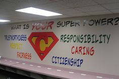 a wall with some writing on it that reads what is your super power? responsible ability caring