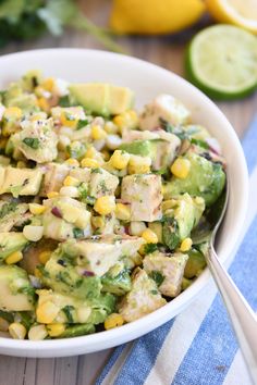 a white bowl filled with corn and avocado salad