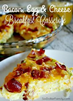 bacon, egg and cheese breakfast casserole on a plate with a glass bowl in the background