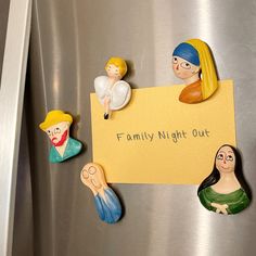 magnets on the side of a refrigerator that say family night out and three little angels