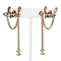 These drop chain earrings are in gold tone metal and feature CC's dangling off long chains with post back earring closure. Origin: FranceCondition: New and never wornAccompanied by: Chanel box, Chanel pouch, retail UPC and ribbonMeasurements: 2.5" height x 1" width Chain Earrings Gold, Chanel Pouch, Cc Earrings, Jewelry Gift Guide, Chanel Box, Drop Earrings Gold, Chanel Inspired, Chanel Logo, Earrings Metal