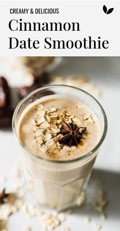 a glass filled with cinnamon date smoothie on top of a table