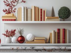 there are many books and vases on the shelves with christmas decorations in front of them